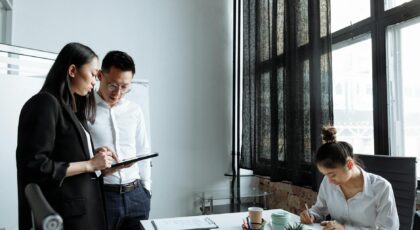 Professionals collaborating in a modern office environment, focusing on planning and teamwork.